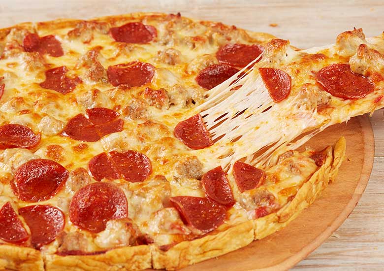 Tavern-style restaurant pizza with a cheese pull