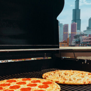 pepperoni and sausage pizza grilling
