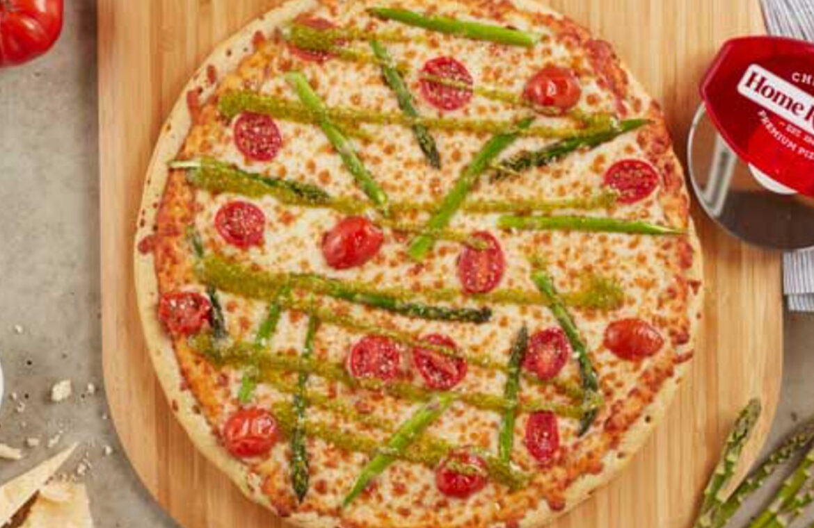 Pizza topped with asparagus and tomatoes