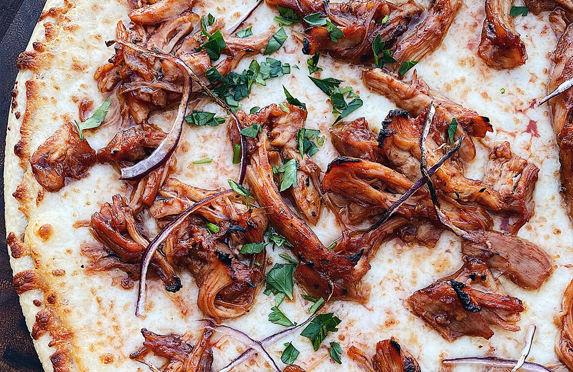Pizza topped with shredded BBQ chicken thighs