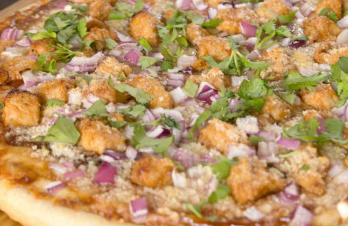 Pizza toped with chicken, red onion, cilantro and BBQ sauce