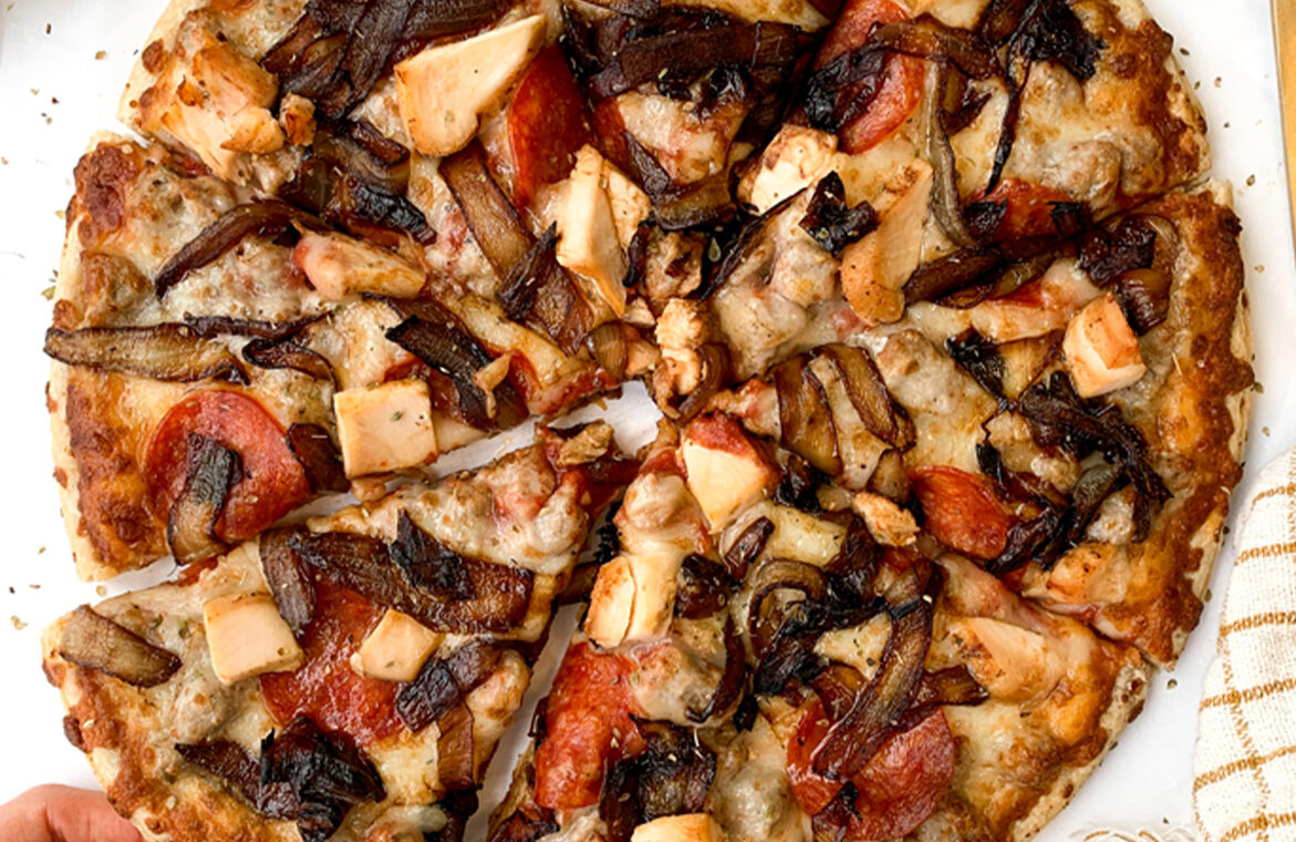 Pizza topped with balsamic chicken and caramelized onions