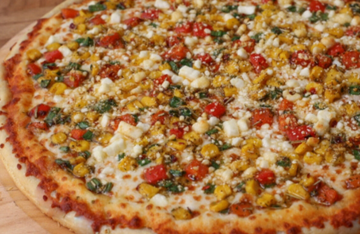 Pizza topped with corn and other fresh ingredients