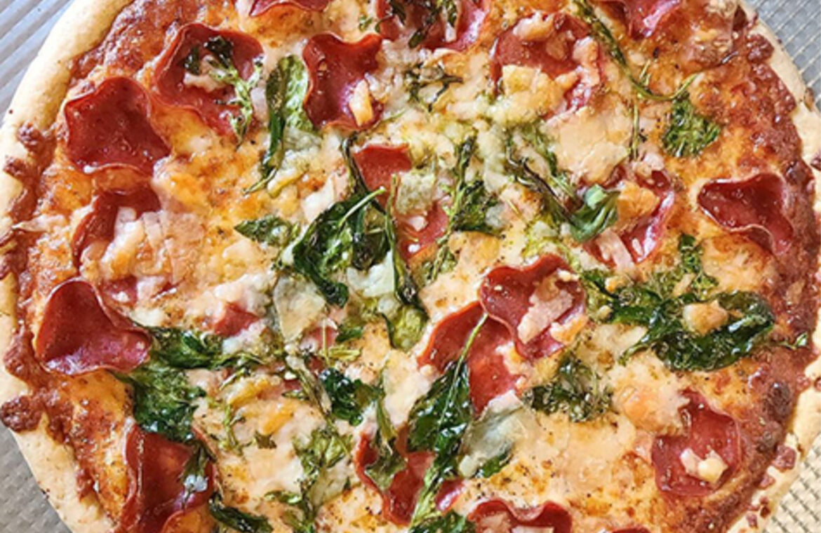 Turkey pepperoni pizza with spinach and arugula
