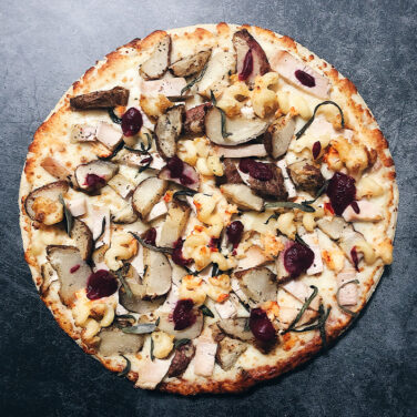 Pizza topped with Thanksgiving leftovers