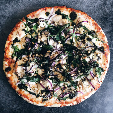 Pizza with ingredients spread out on top