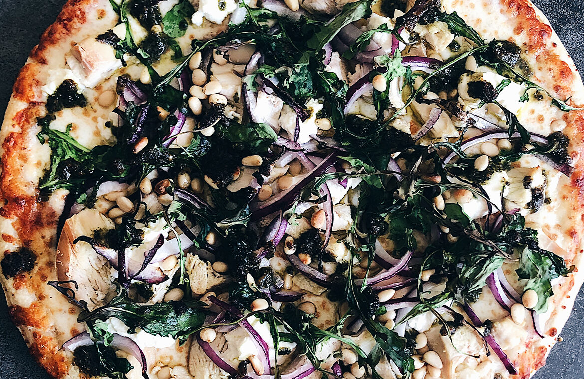 Pizza with ingredients spread out on top