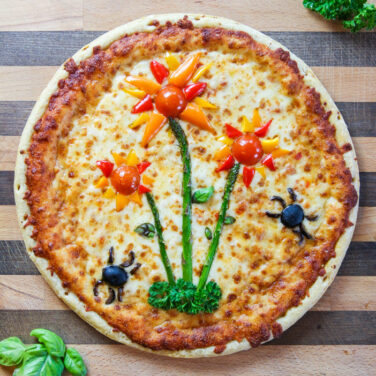 Pizza with ingredients shaped into flowers