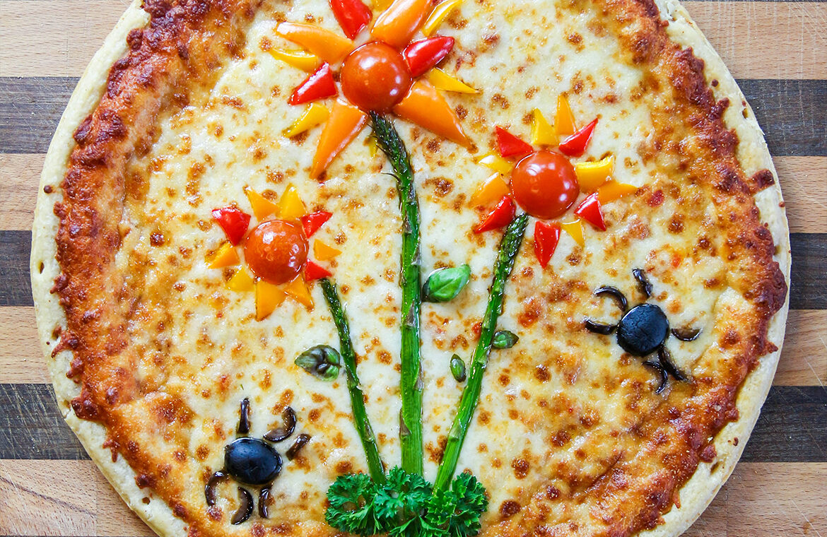 Pizza Topped with vegetables in the shape of flowers