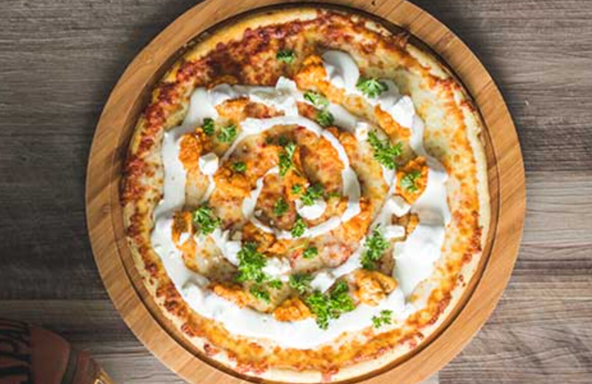 Pizza topped with buffalo chicken ranch and more