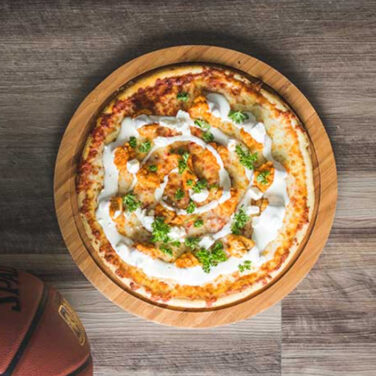 Pizza topped with buffalo chicken ranch and more