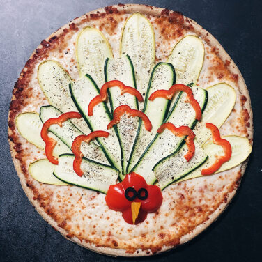 Pizza with vegetables in the shape of a turkey
