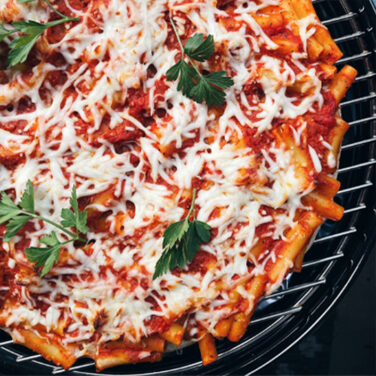 Pizza topped with pasta