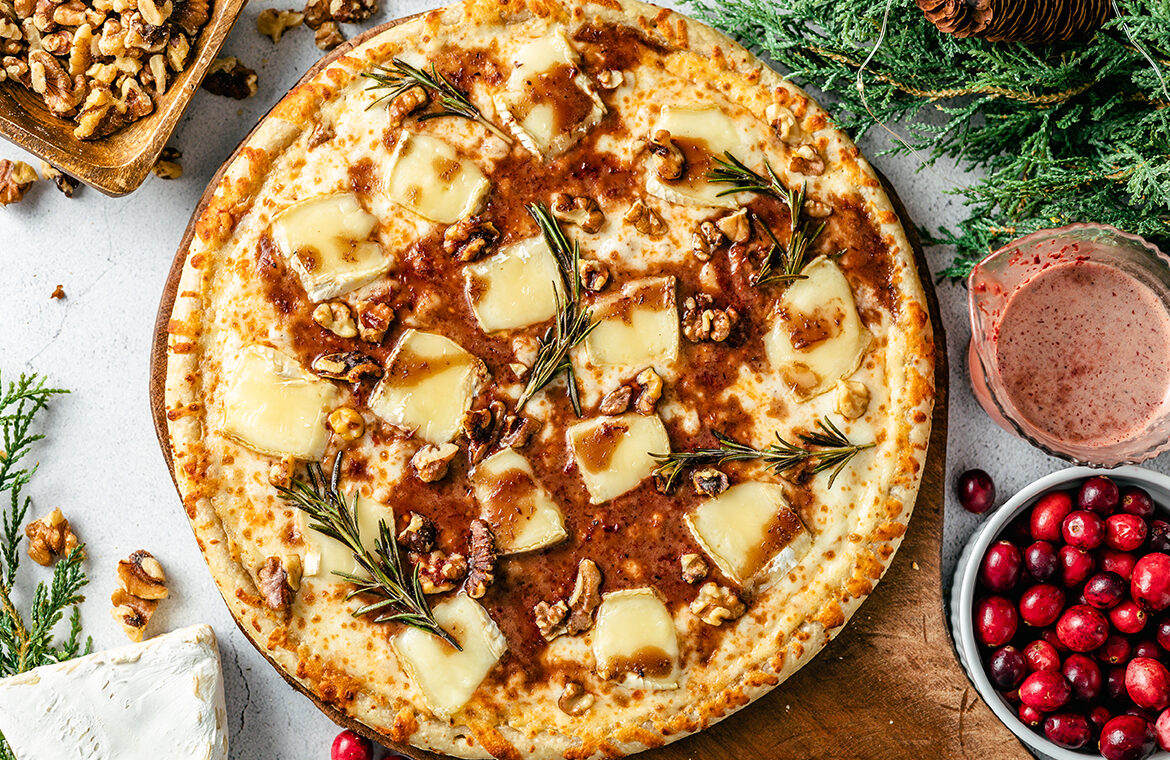 Pizza topped with brie cheese and cranberry sauce
