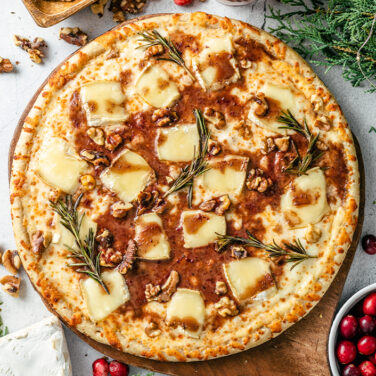 Pizza topped with brie cheese and cranberry sauce