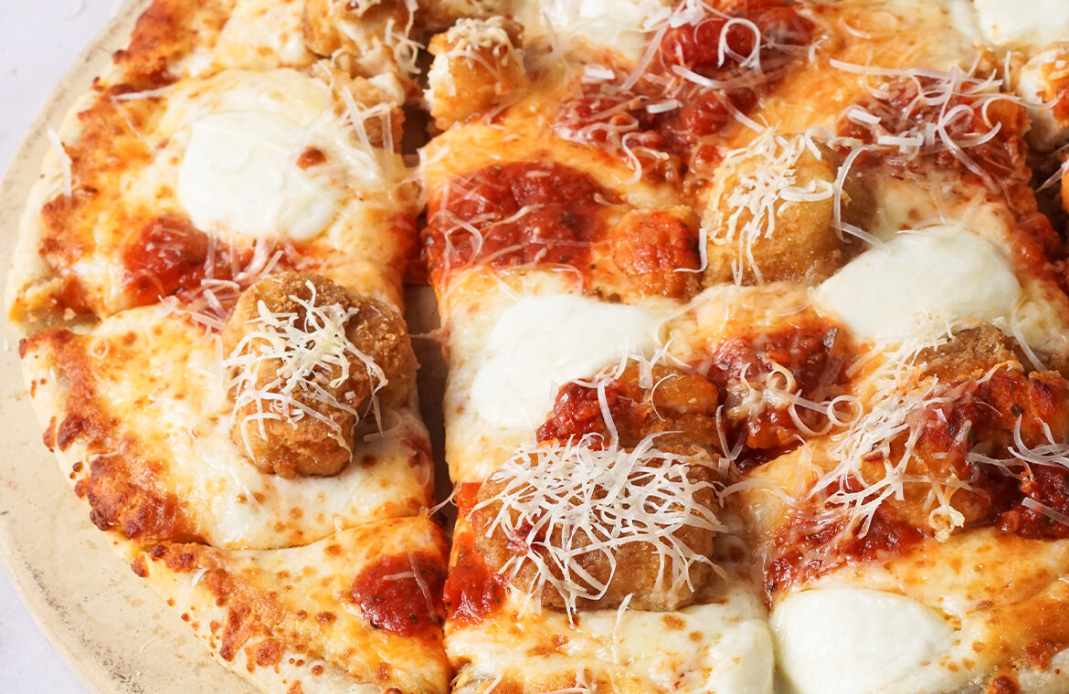 Pizza topped with chicken and parmesan