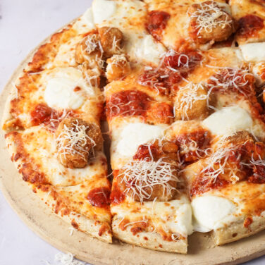 Pizza topped with chicken and parmesan