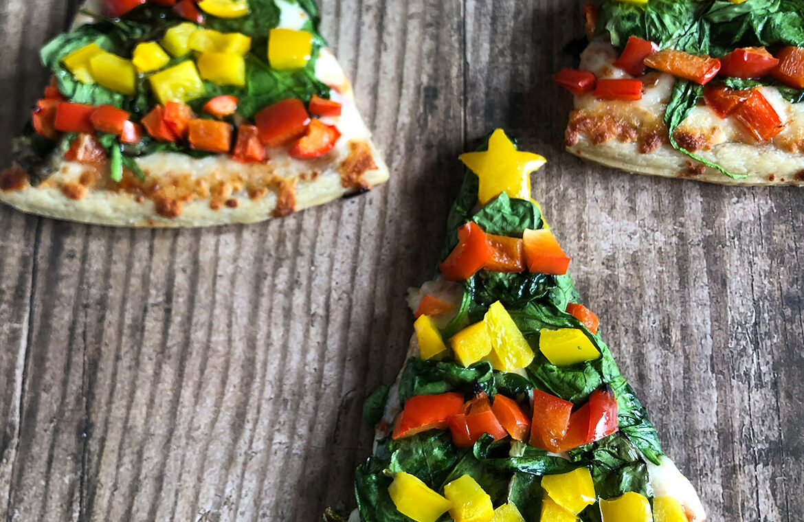 Pizza slices individually decorated to look like a Christmas tree