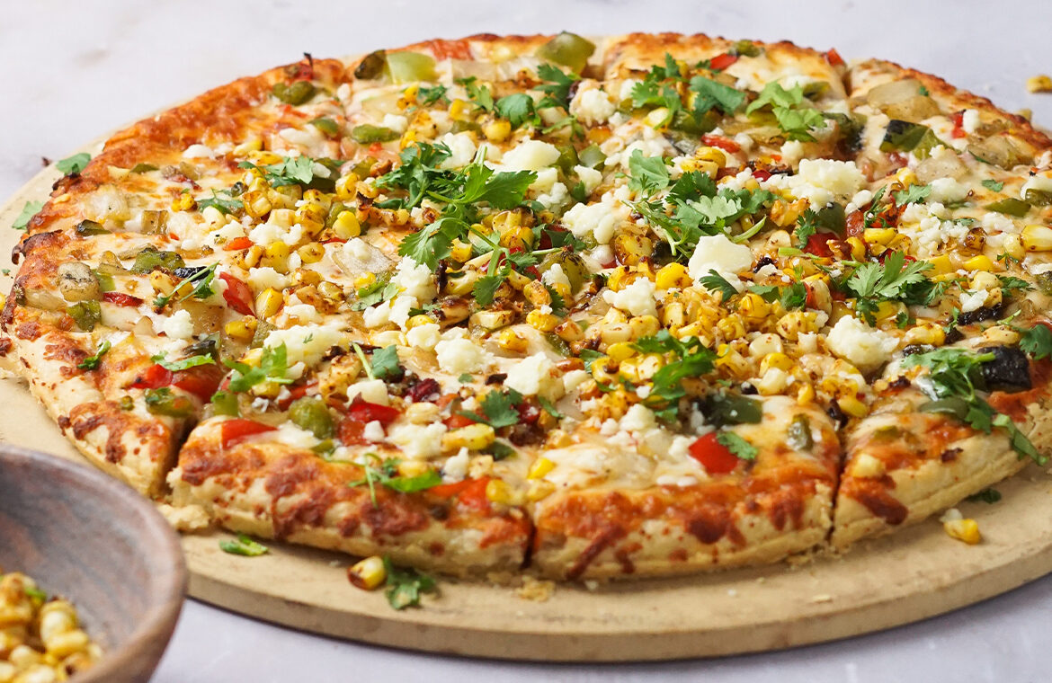Pizza topped with corn and other ingredients