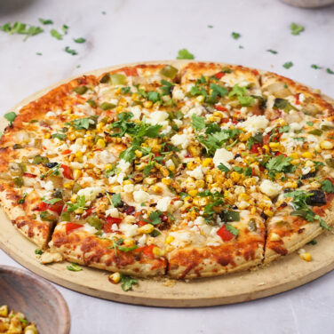 Pizza topped with corn and other ingredients