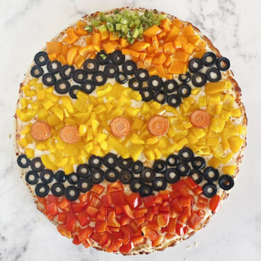 Pizza topped with colorful ingredients resembling an easter egg