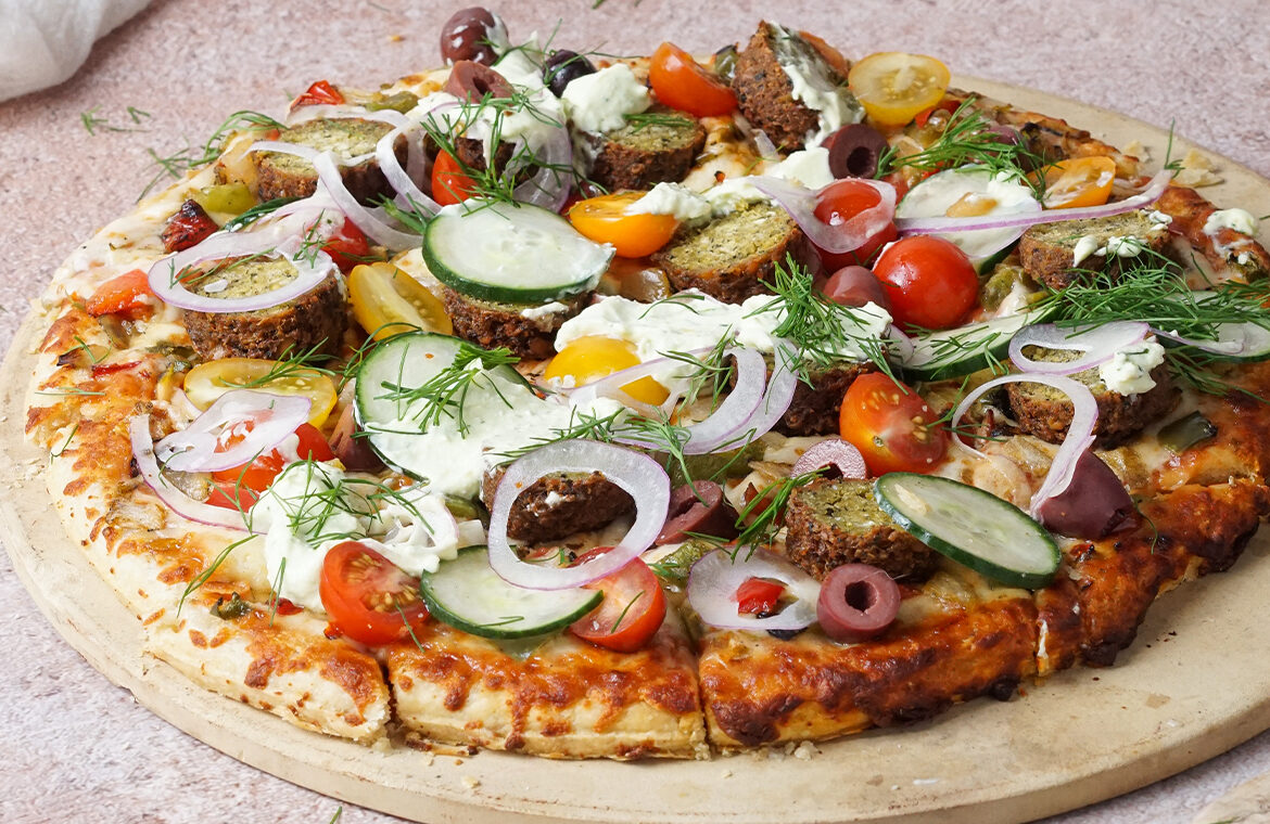 Pizza topped with falafel ingredients