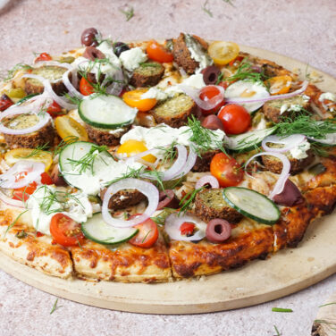 Pizza topped with falafel ingredients