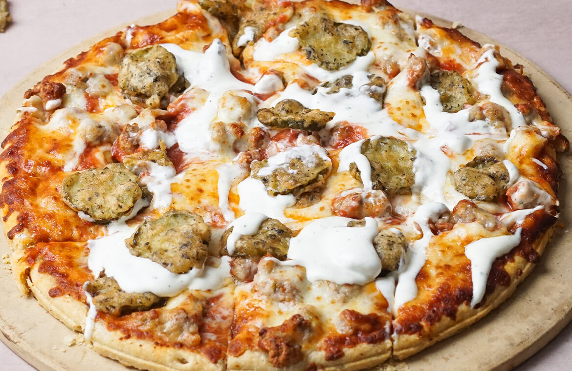 Pizza topped with fried pickles and other ingredients