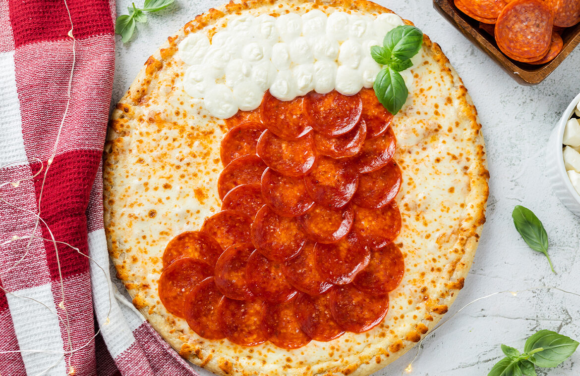 Pizza topped with ingredients in the shape of a christmas stocking