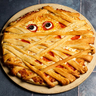 Pizza covered in crescent dough resembling a mummy