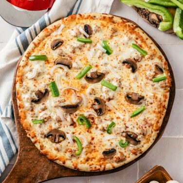Pizza topped with mushrooms and peppers