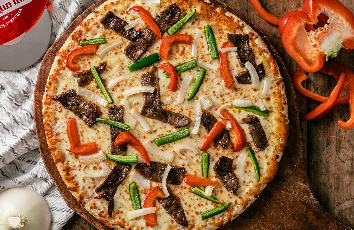 Pizza topped with beef and peppers
