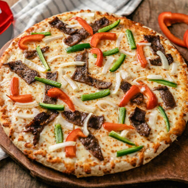 Pizza topped with beef and peppers