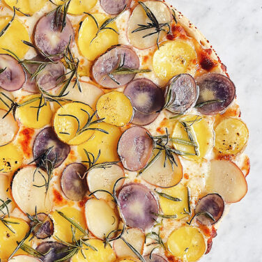 Pizza topped with potatoes and rosemary