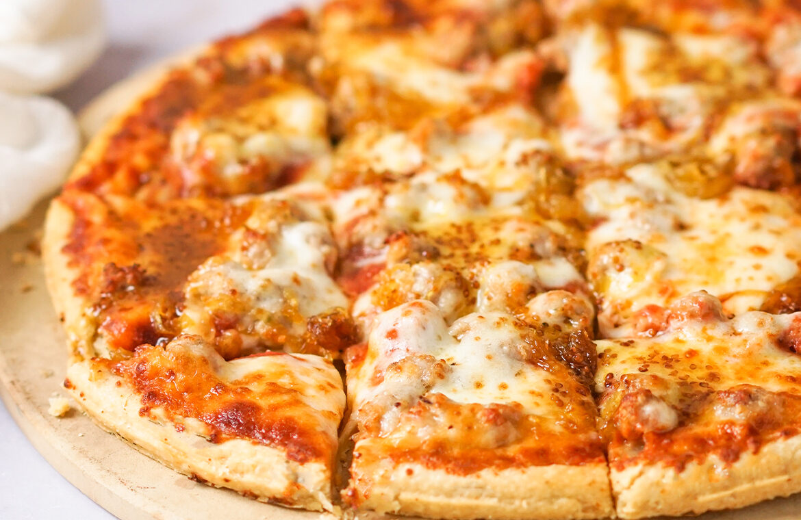 Sausage pizza topped with caramelized onion