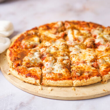 Sausage pizza topped with caramelized onion