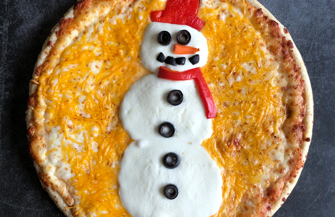 Pizza decorated with toppings in the shape of a snowman
