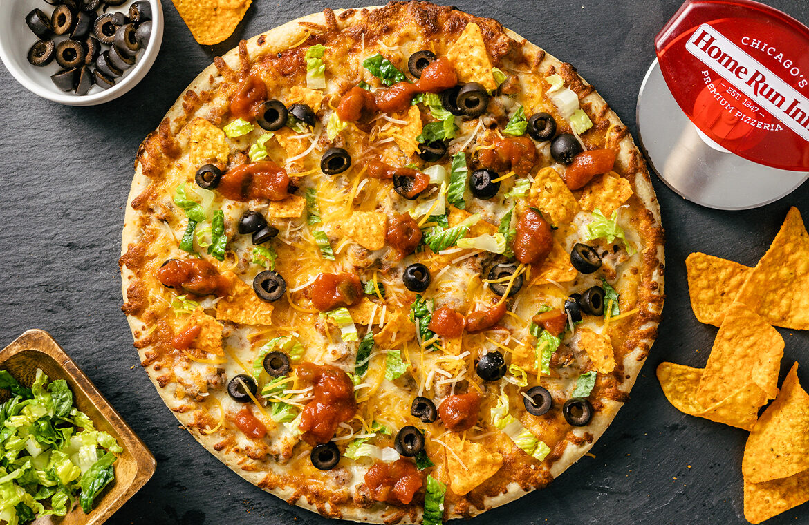 Pizza topped with taco ingredients and doritos