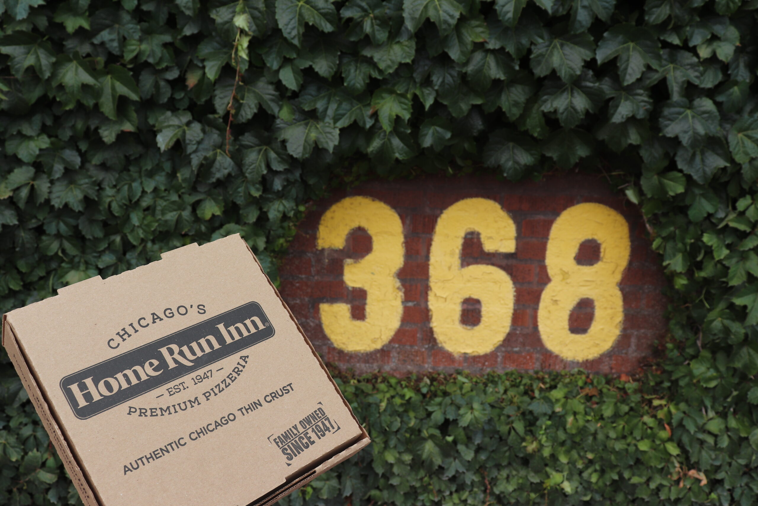 home run inn pizza box at the cubs ballpark with green iny and yellow number 368