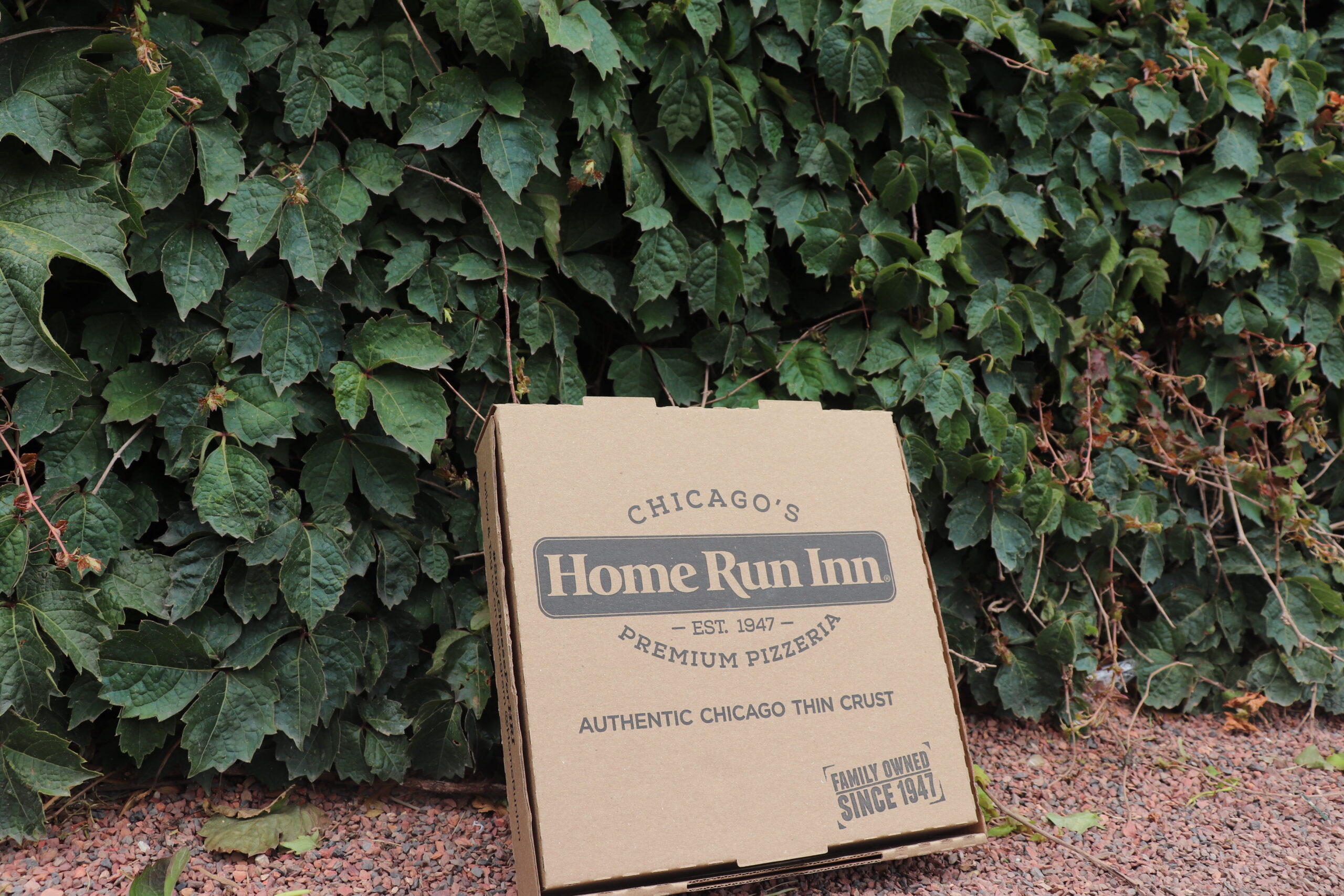 home run inn pizza box at the cubs ballpark with green ivy