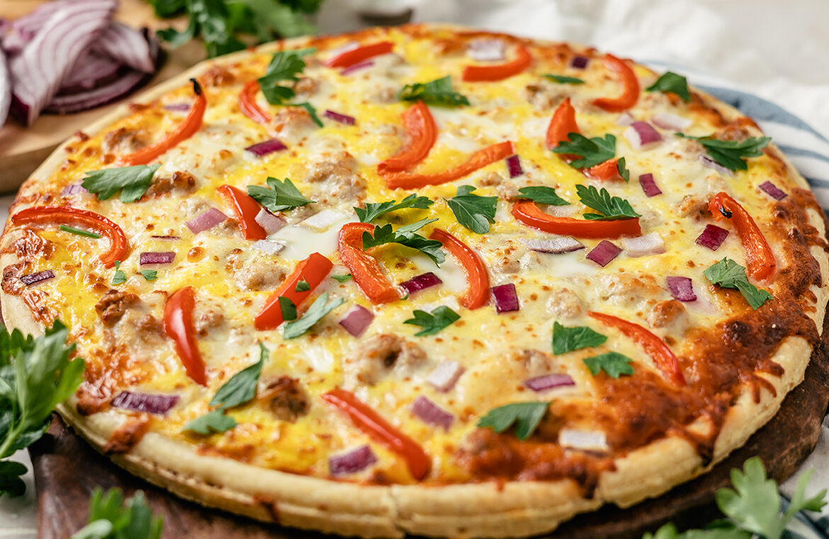 Pizza topped with bell peppers onions and more