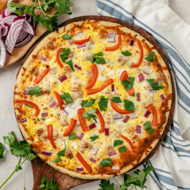 Pizza topped with bell peppers onions and more