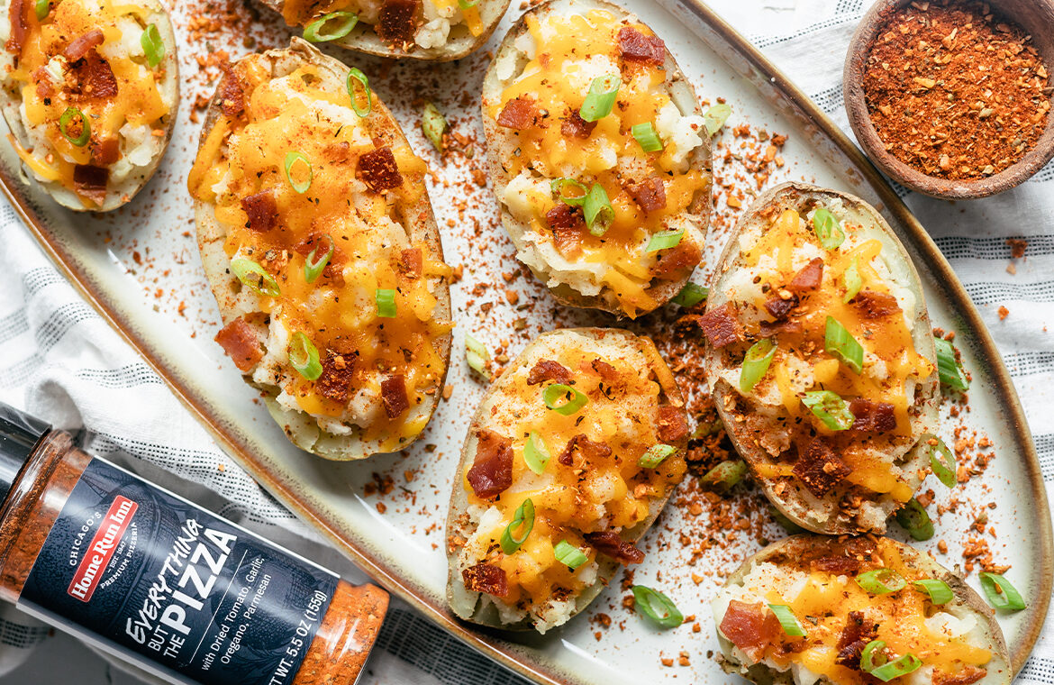 Double baked potatoes topped with cheese, bacon, green onion, and pizza seasoning