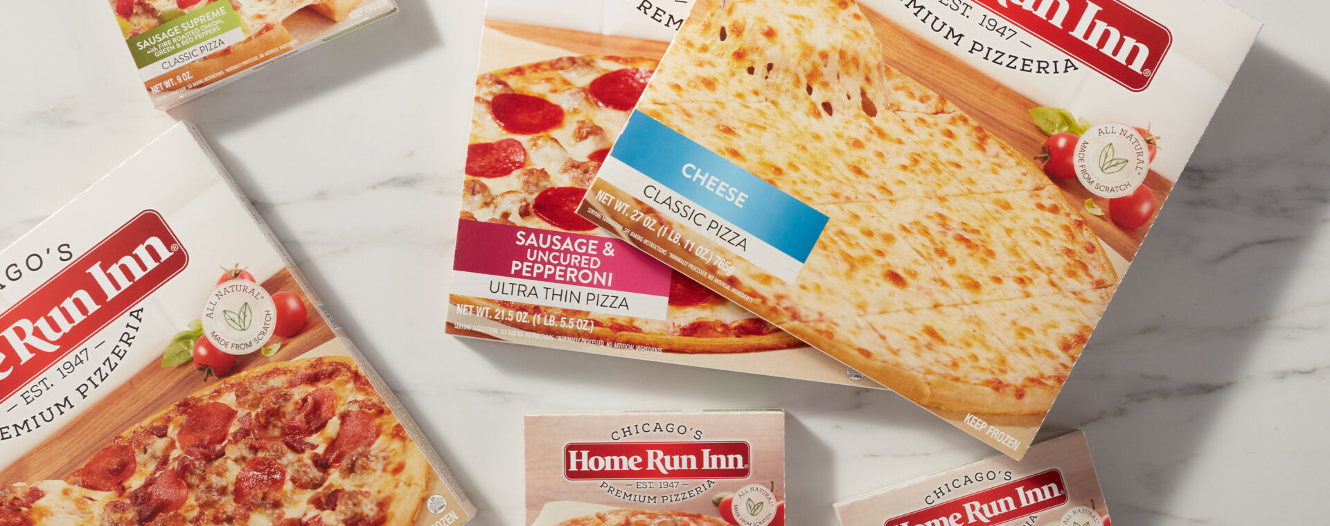 Home Run Inn frozen pizza boxes sitting on marble countertop