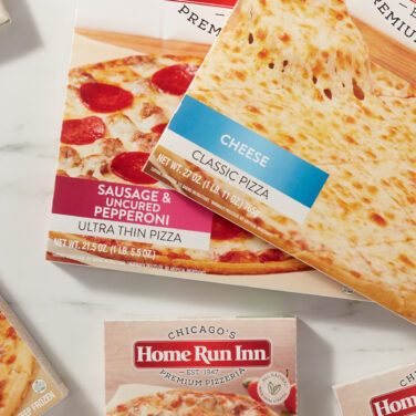 Home Run Inn frozen pizza boxes sitting on marble countertop