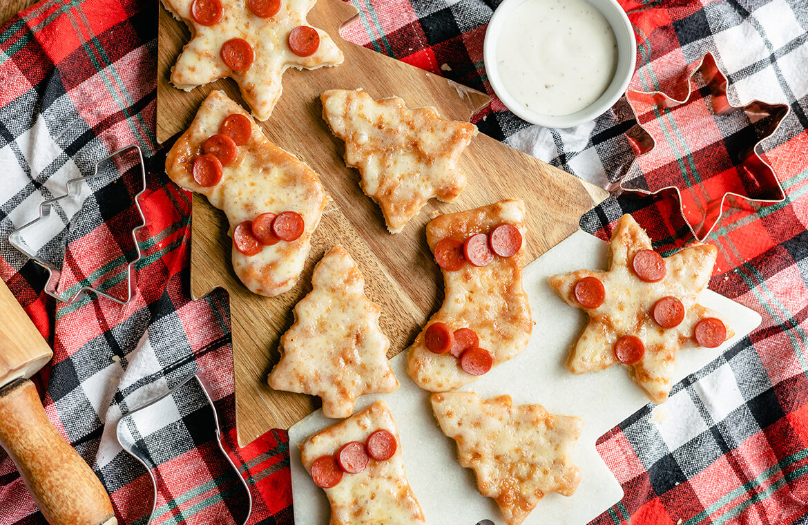 Pizza slices cut into holiday shapes with mini pepperoni