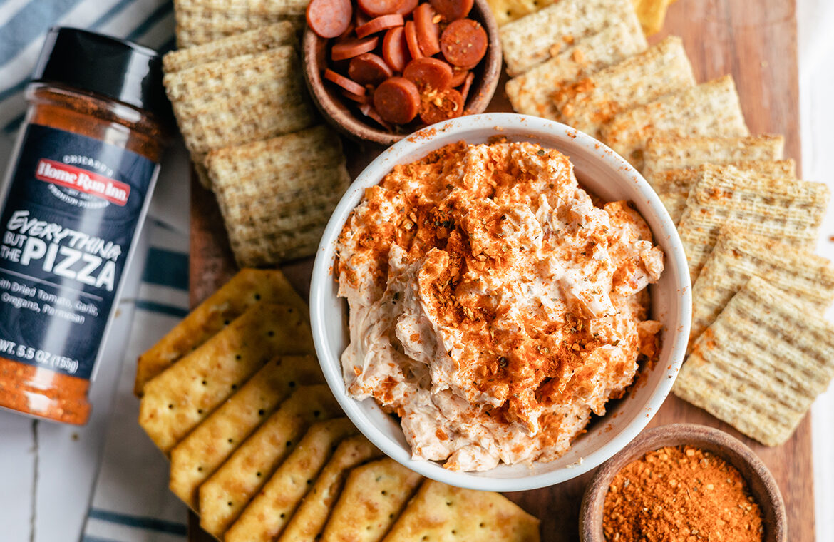 Pizza dip with crackers spread out around it