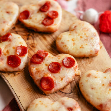 Pizza cut out in the shape of hearts and topped with mini pepperonis