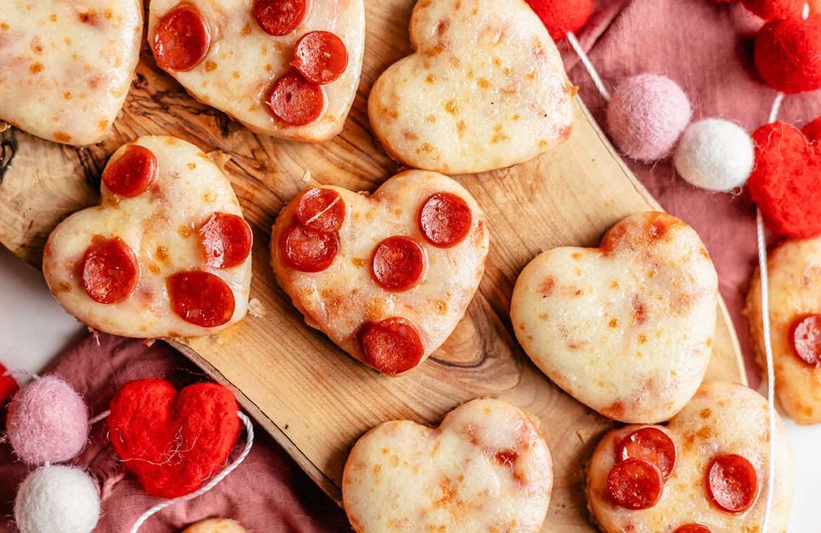 Pizza cut out in the shape of hearts and topped with mini pepperonis