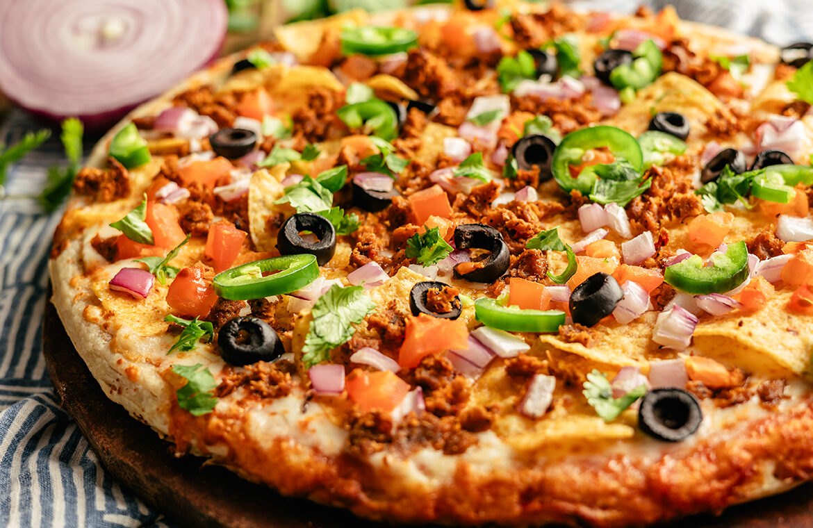 Pizza topped with nacho ingredients